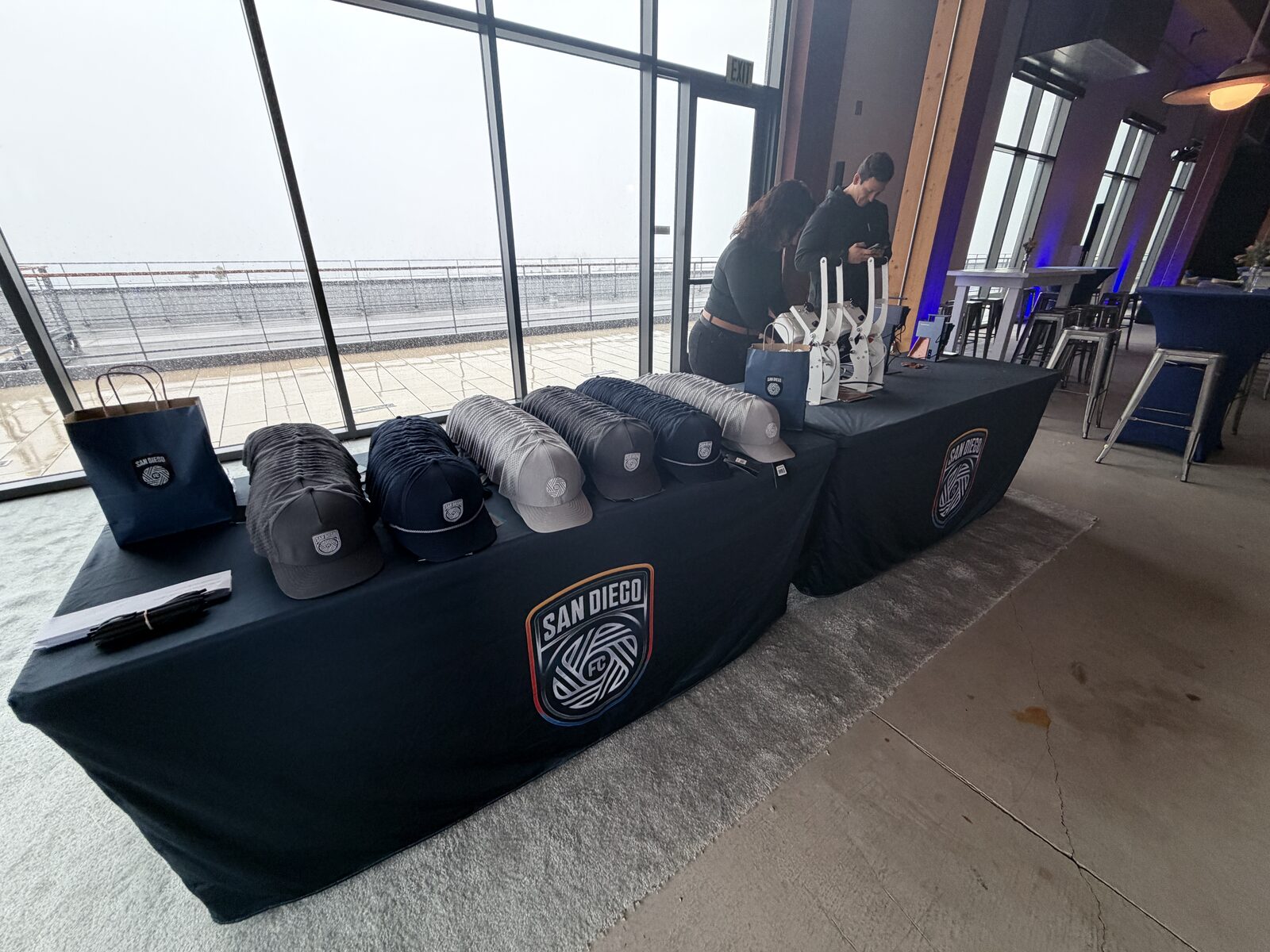 Custom caps displayed on the hat bar merch table